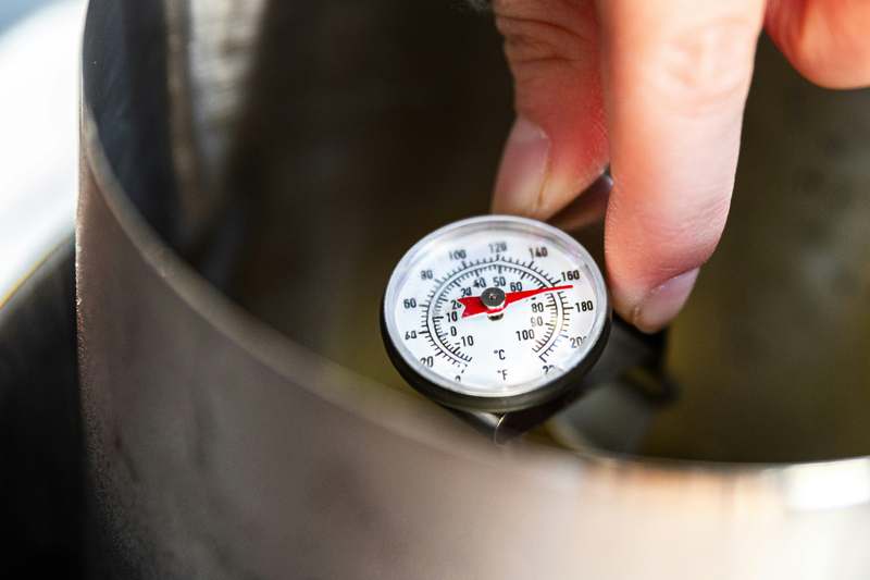 Close-up of a high-accuracy digital refrigerator thermometer mounted inside fridge